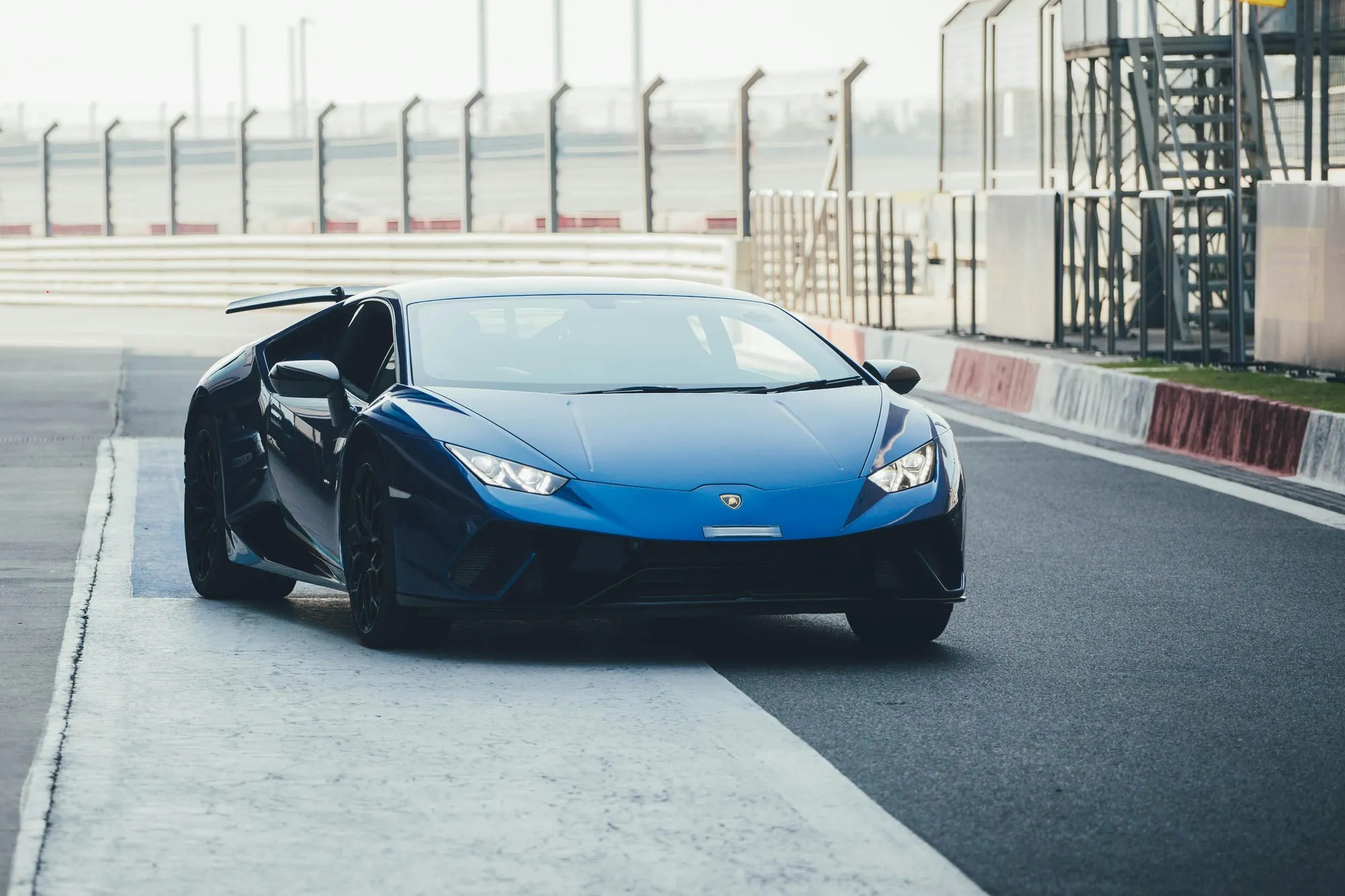 A blue Lamborghini Huracán on a racetrack