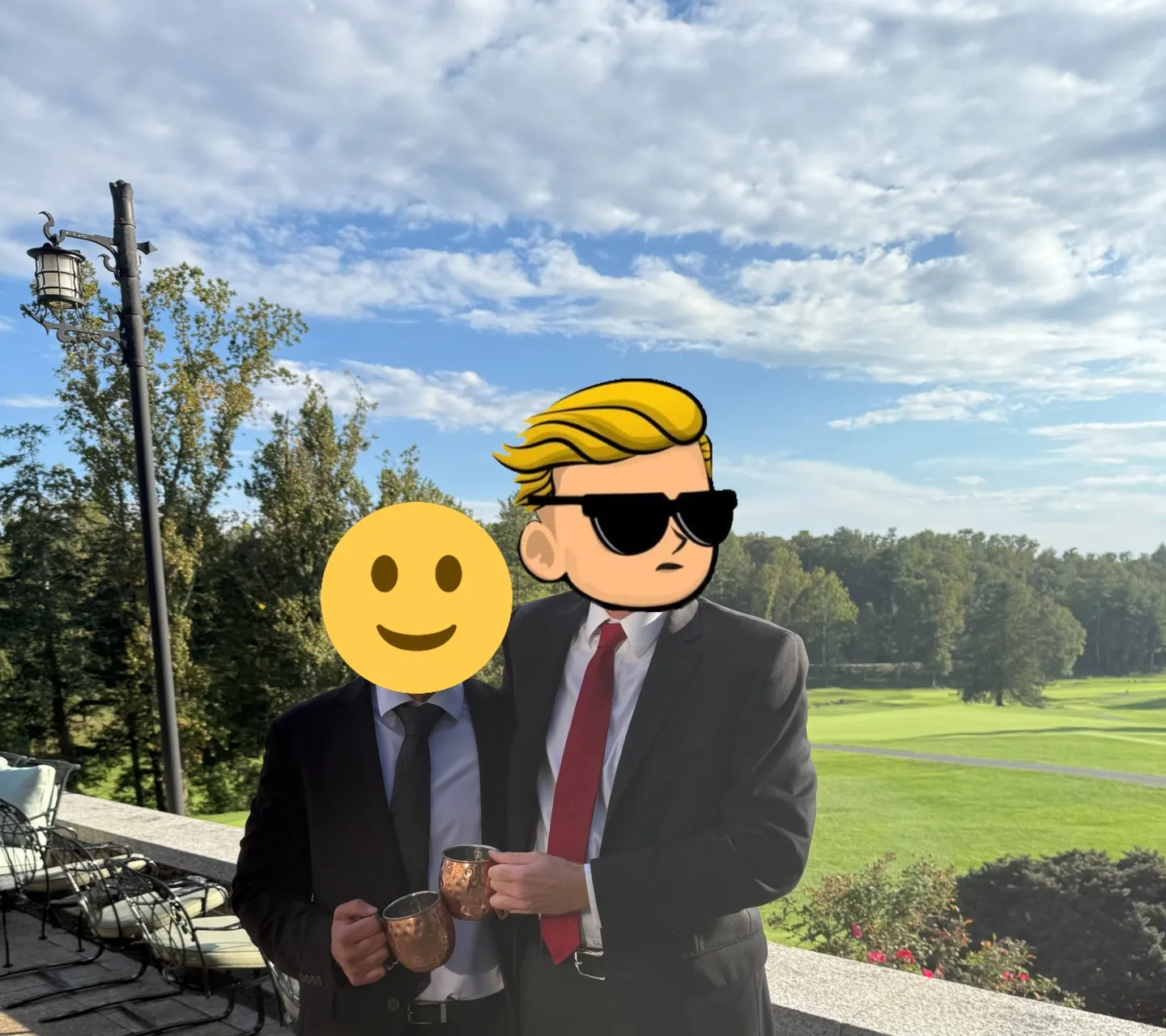 The author with a friend, drinks in hand, on a stone terrace overlooking a golf course